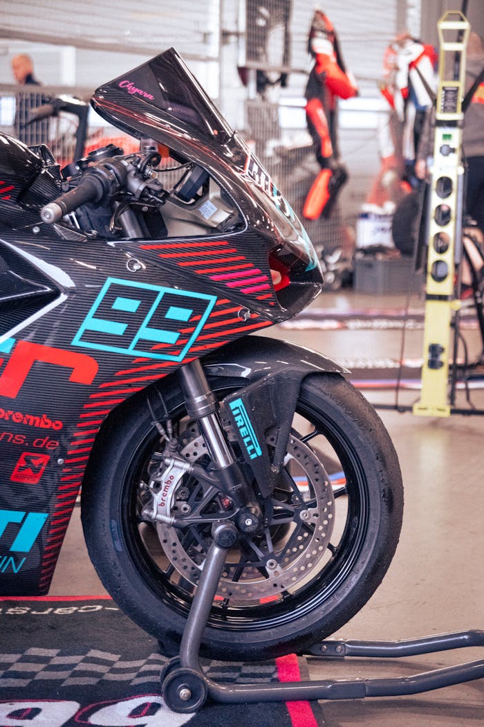 gallery-1 Close-up of a racing motorcycle in a Nürburgring garage, embodying speed and precision.
